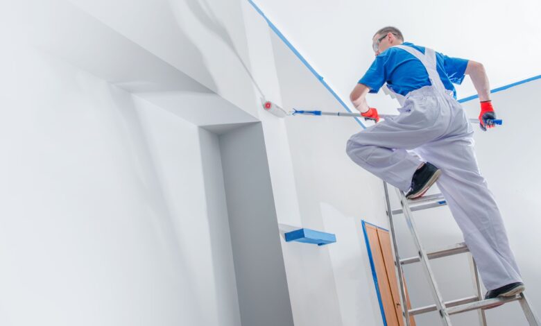 A professional contractor busy in painting a wall